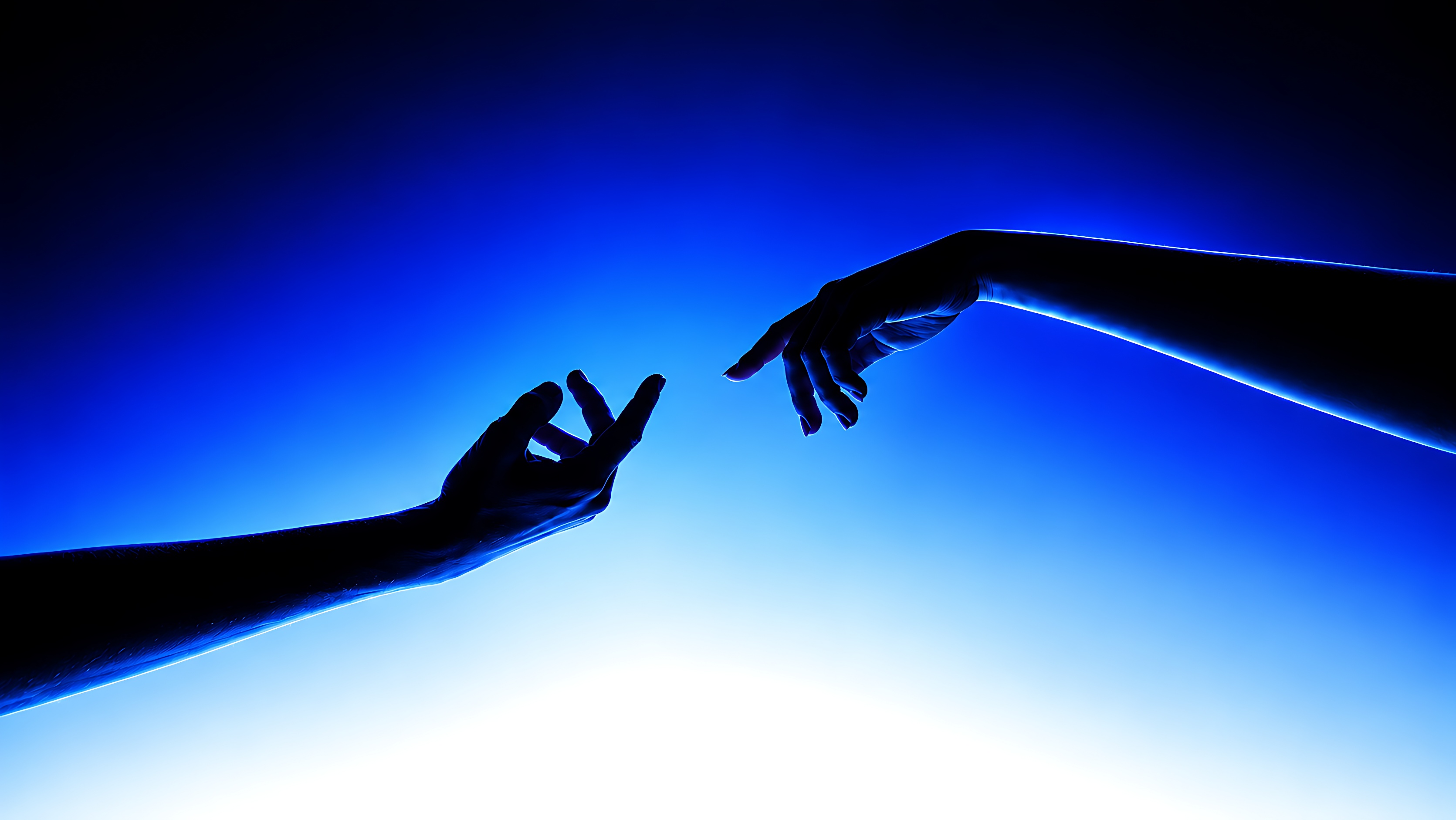 Two hands reaching towards each other through blue light